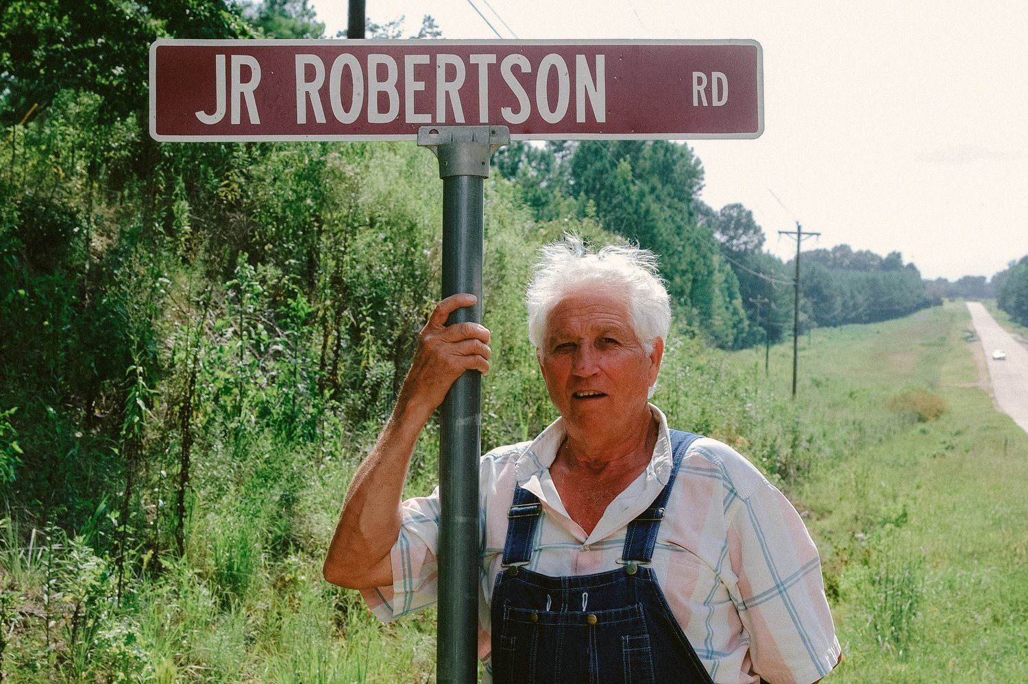 Junior standing at the JR Robertson Rd sign